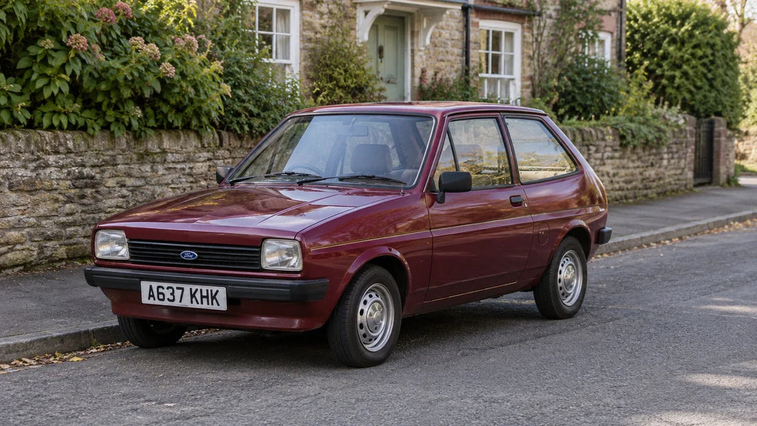 Burgundy coloured car parked outside a cottage with a green front door. 